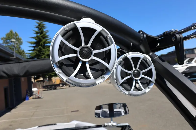 Slide: The Image of Speakers on a 2021 Tigé 22RZX boat, mounted on a black frame, outdoors. - 49
