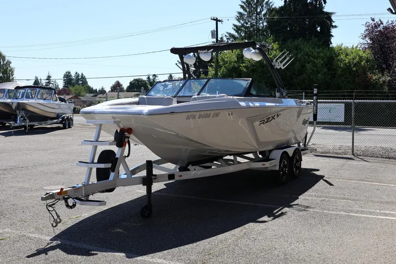 Slide: The Image of 2021 Tigé 22RZX boat on trailer in parking lot, ready for transport. - 7