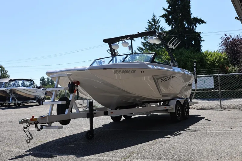 Slide: The Image of 2021 Tigé 22RZX boat on trailer in outdoor setting, ready for transport. - 8