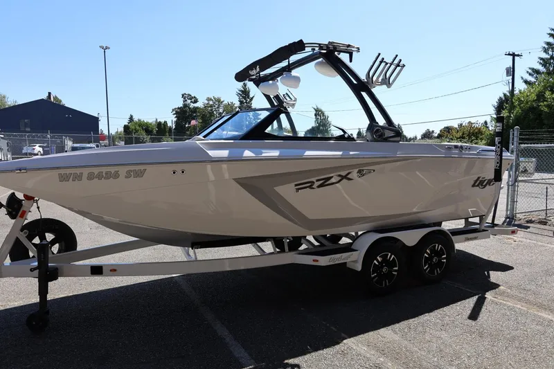 Slide: The Image of 2021 Tigé 22RZX boat on trailer, parked outdoors, side view. - 9
