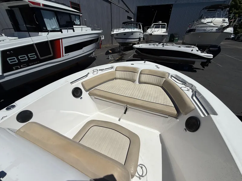 Slide: The Image of 2018 Sea Fox 186 Commander boat interior with beige seating, docked among other boats. - 14