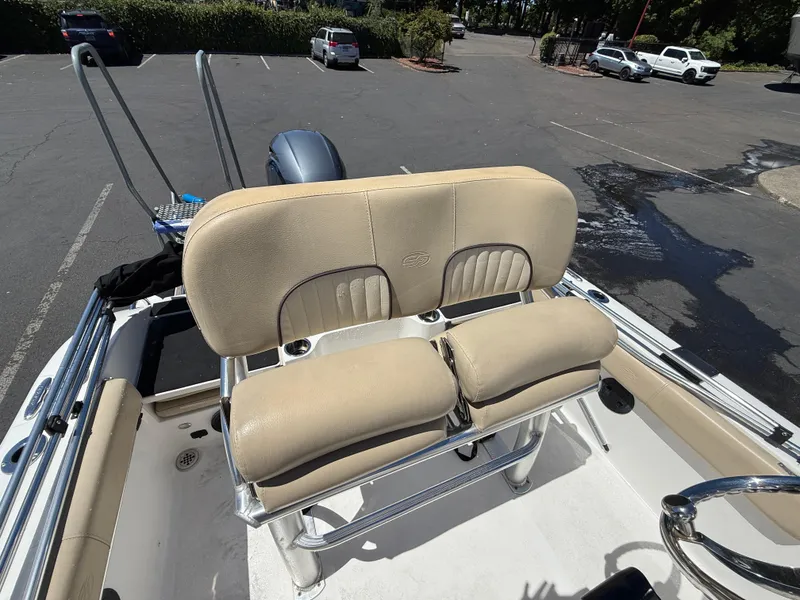 Slide: The Image of 2018 Sea Fox 186 Commander boat with beige seating in a parking lot. - 15
