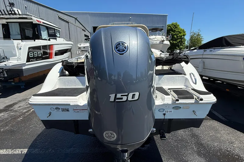 Slide: The Image of 2018 Sea Fox 186 Commander boat with Yamaha 150 outboard motor, parked outdoors. - 16