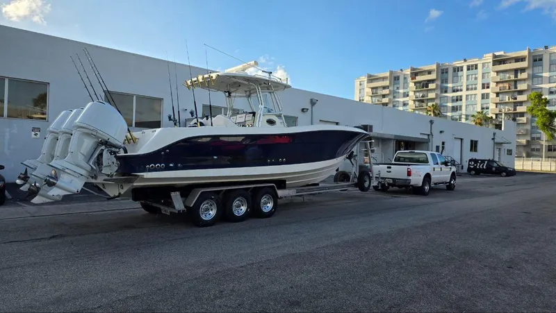 The Image of 2008 Hydra-Sports Vector 3300 CC boat on trailer, parked near buildings. - 1