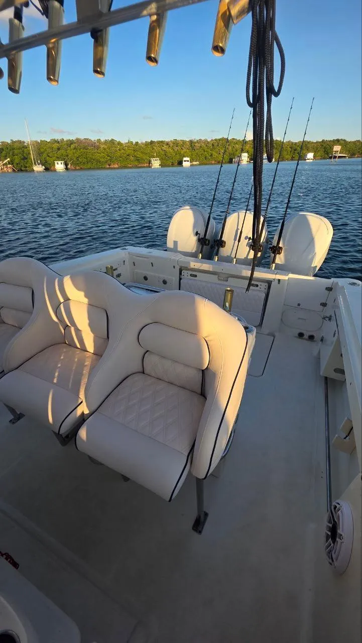 Slide: The Image of 2008 Hydra-Sports Vector 3300 CC boat interior with cushioned seats and fishing rods. - 4