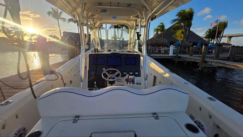 Slide: The Image of 2008 Hydra-Sports Vector 3300 CC boat at sunset, docked near palm trees and waterfront. - 6