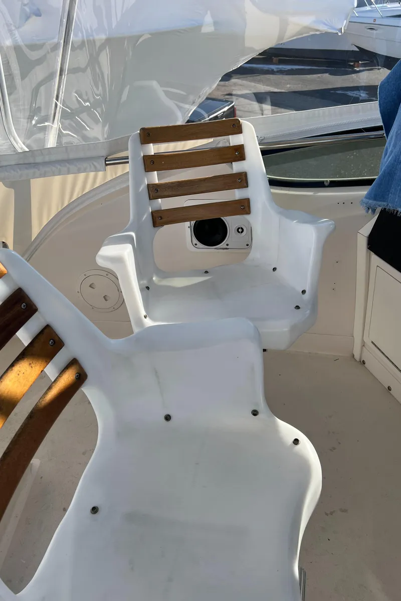 Slide: The Image of 1992 Blackfin 29 Flybridge boat interior with white and wood-accented seating. - 12