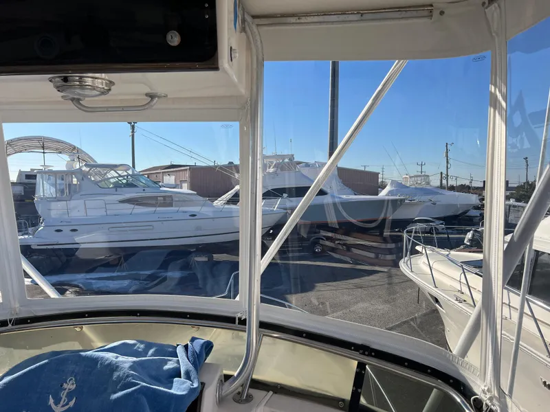 Slide: The Image of 1992 Blackfin 29 Flybridge view, marina setting with multiple boats, clear blue sky. - 13