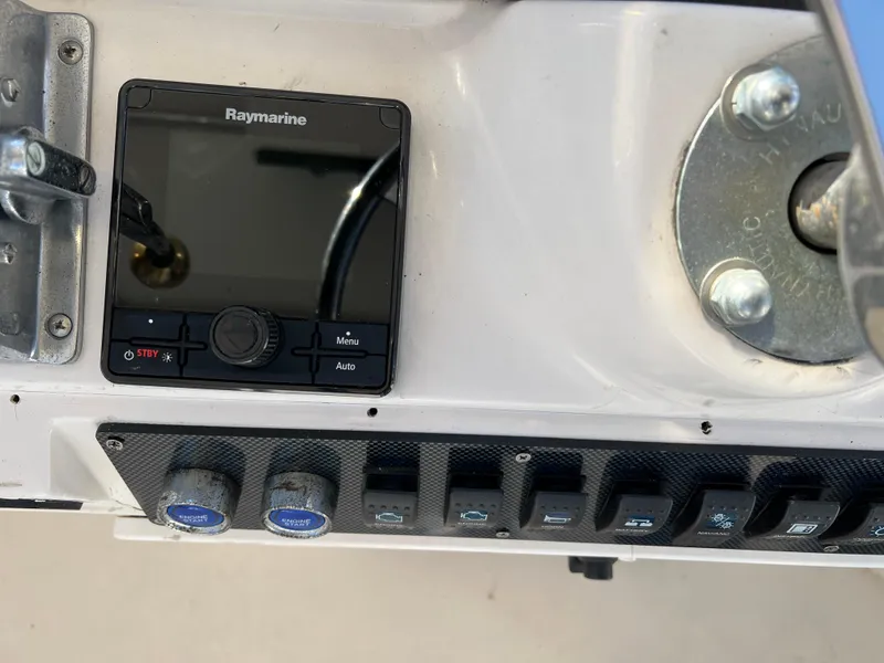 Slide: The Image of Control panel of a 1992 Blackfin 29 Flybridge with Raymarine display and switches. - 16