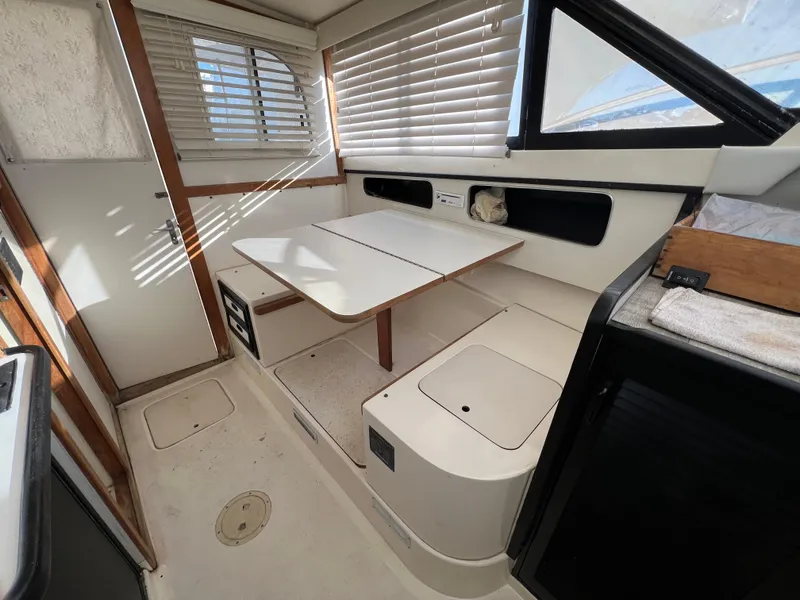 Slide: The Image of Interior of a 1992 Blackfin 29 Flybridge boat with seating and table. - 26
