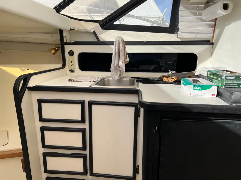 Slide: The Image of Interior of 1992 Blackfin 29 Flybridge boat with kitchenette and sink area. - 27
