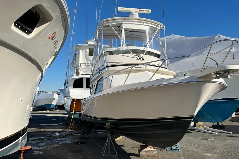Slide: The Image of 1992 Blackfin 29 Flybridge boat in dry dock, surrounded by other vessels. - 4