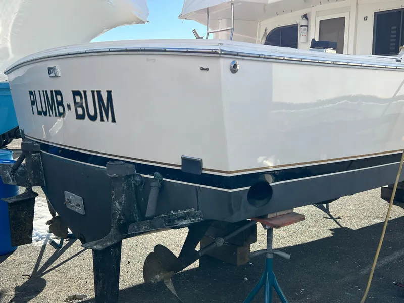 Slide: The Image of 1992 Blackfin 29 Flybridge boat on stands, named "Plumb-Bum," in a marina setting. - 6