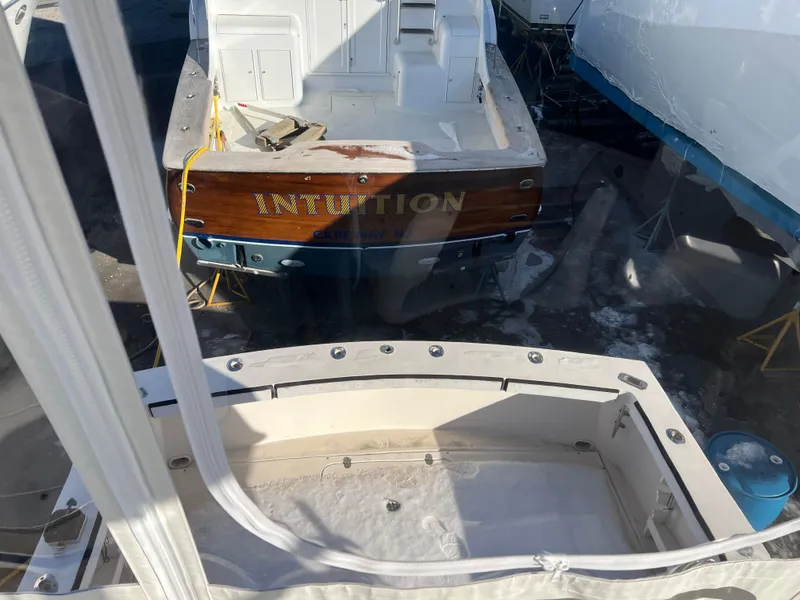 Slide: The Image of 1992 Blackfin 29 Flybridge boat named "Intuition" in a marina, viewed from above. - 7