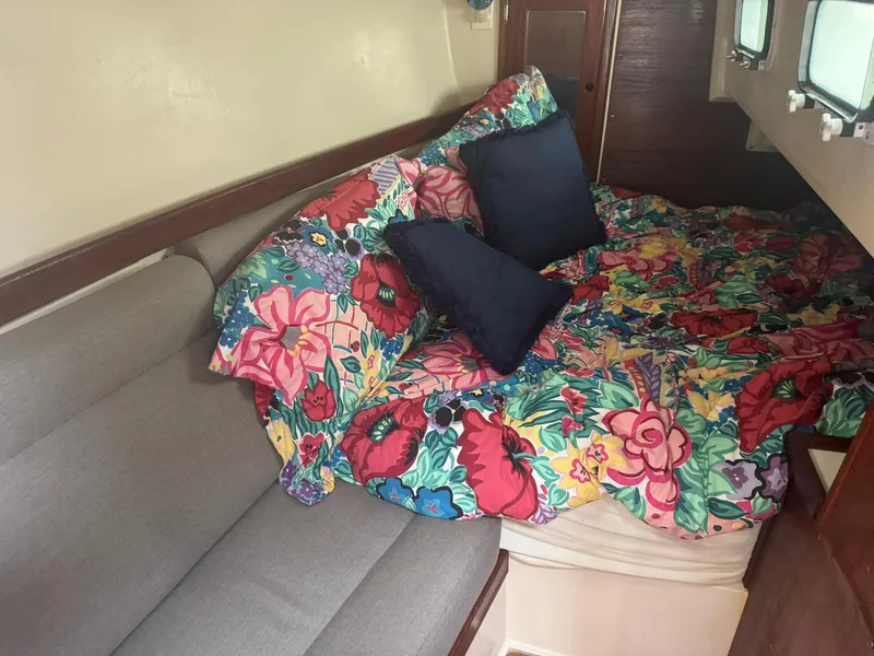 Slide: The Image of Cozy cabin interior of 1989 Catalina 34 with floral bedding and cushions. - 14