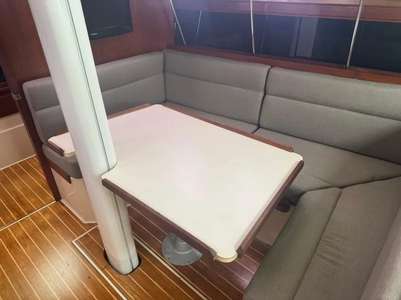 Slide: The Image of Interior of 1989 Catalina 34 sailboat with cozy seating and wooden flooring. - 17