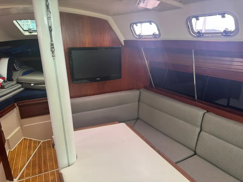 Slide: The Image of Interior of 1989 Catalina 34 sailboat with cozy seating and mounted TV. - 18