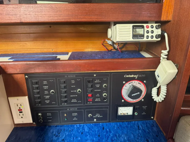 Slide: The Image of Electrical panel of a 1989 Catalina 34 yacht with radio and control switches. - 21