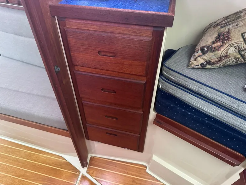 Slide: The Image of Wooden drawers and cushions inside a 1989 Catalina 34 sailboat cabin. - 24
