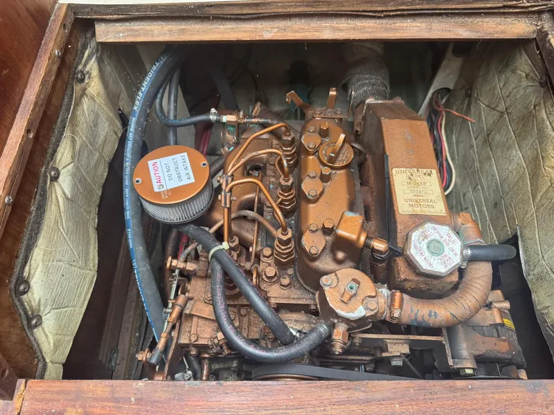 Slide: The Image of Engine compartment of a 1989 Catalina 34 sailboat, featuring a Universal diesel engine. - 27