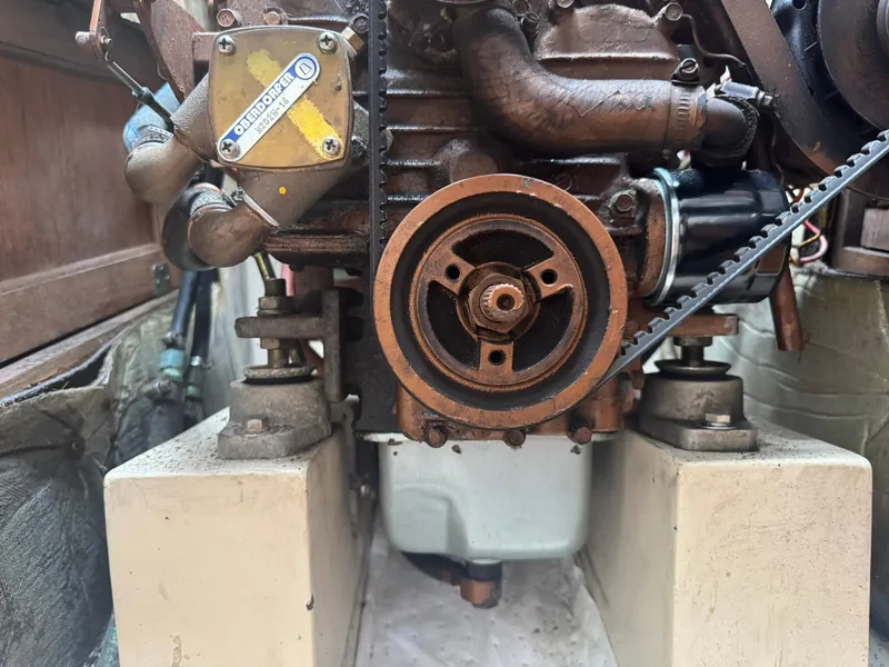 Slide: The Image of Engine of a 1989 Catalina 34 sailboat, featuring visible components and belt system. - 28