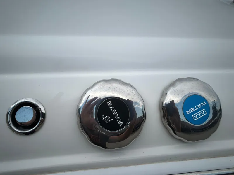 Slide: The Image of Boat fuel and water caps on a 2022 Stingray 212 SC. - 12