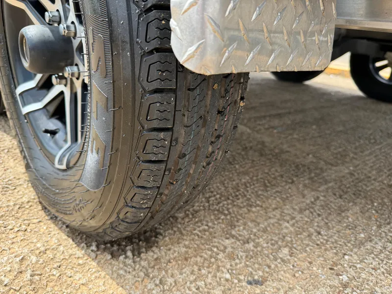 Slide: The Image of Close-up of a 2022 Stingray 212 SC trailer tire on a textured surface. - 16