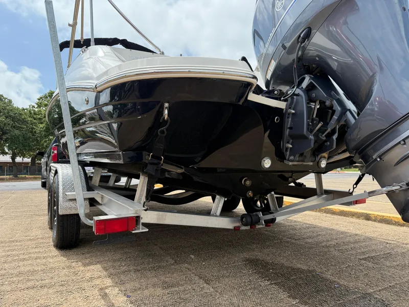 Slide: The Image of 2022 Stingray 212 SC boat on trailer, rear view, outdoors. - 20