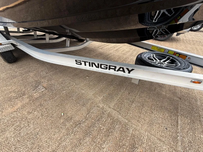 Slide: The Image of 2022 Stingray 212 SC boat trailer with visible tire and branding. - 40