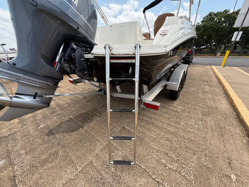 Slide: The Image of 2022 Stingray 212 SC boat on trailer with ladder and Yamaha outboard motor. - 41
