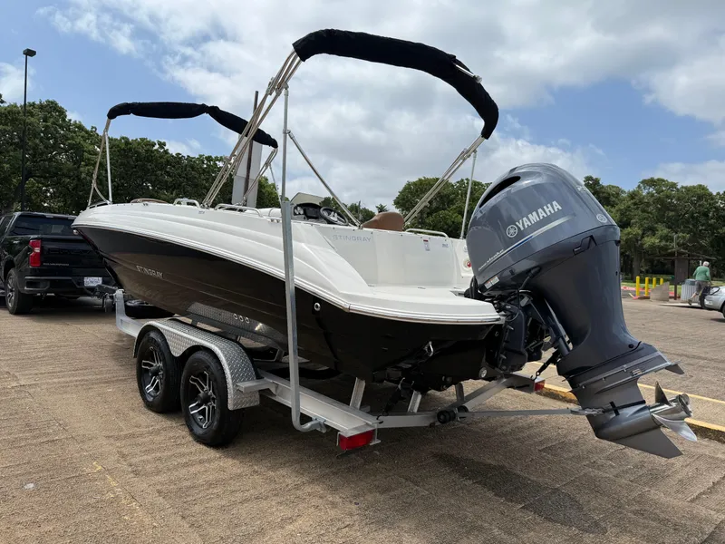 Slide: The Image of 2022 Stingray 212 SC boat on trailer with Yamaha outboard motor in parking lot. - 7