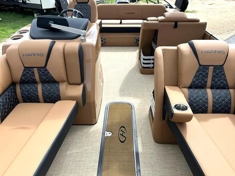 Slide: The Image of 2023 Harris Grand Mariner 230 interior with luxurious tan and black seating. - 1