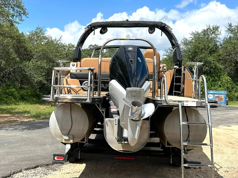 Slide: The Image of 2023 Harris Grand Mariner 230 pontoon boat with powerful outboard motor, parked outdoors. - 18