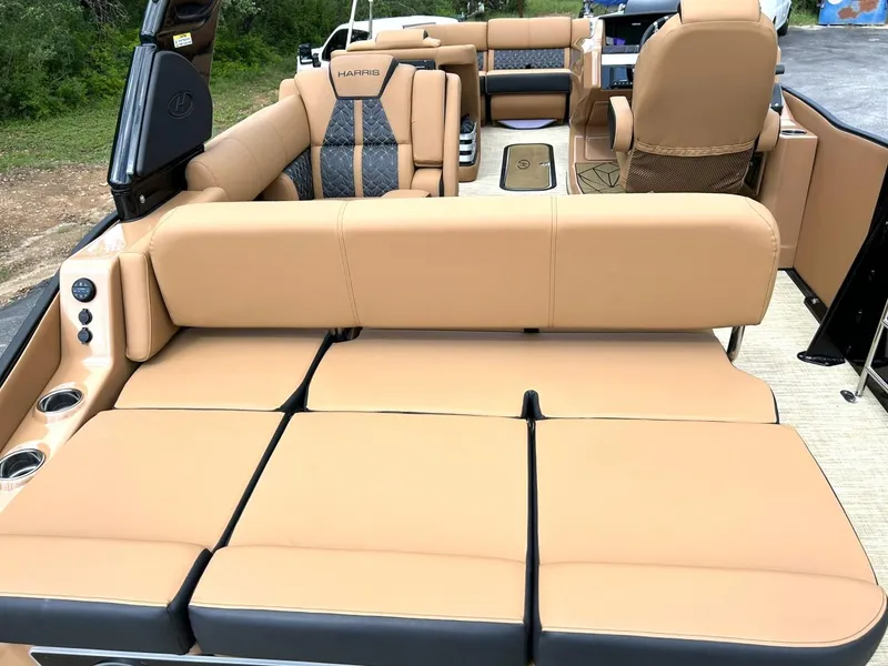 Slide: The Image of 2023 Harris Grand Mariner 230 boat interior with tan leather seating and cup holders. - 24