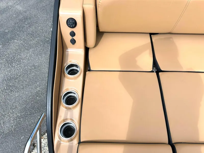 Slide: The Image of 2023 Harris Grand Mariner 230 boat interior with tan seating and cup holders. - 27