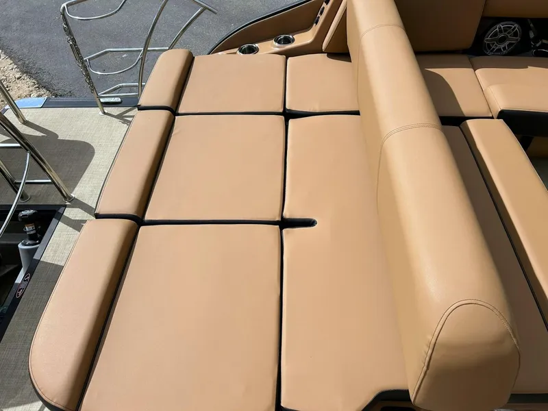 Slide: The Image of 2023 Harris Grand Mariner 230 boat with tan cushioned seating and stainless steel railings. - 30