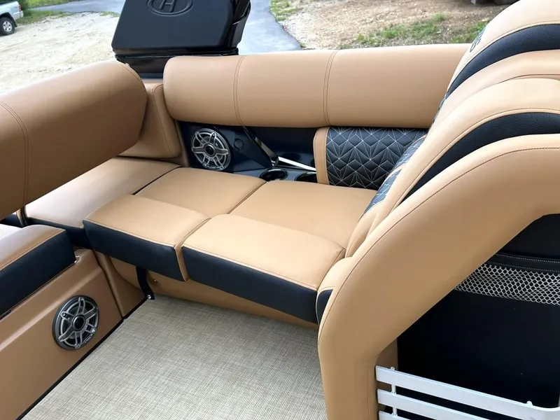 Slide: The Image of Luxurious seating on 2023 Harris Grand Mariner 230 boat with tan upholstery and built-in speakers. - 36