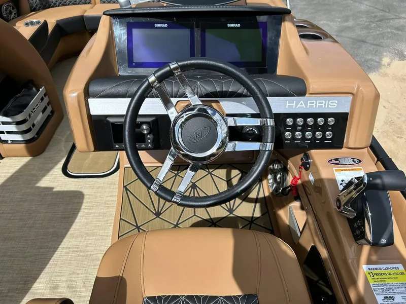 Slide: The Image of 2023 Harris Grand Mariner 230 dashboard with steering wheel and dual Simrad displays. - 39