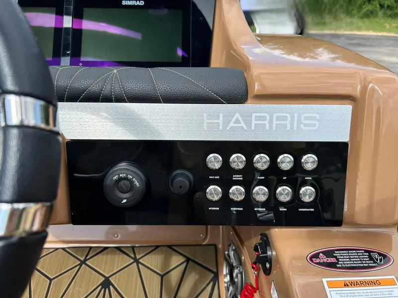 Slide: The Image of Control panel of 2023 Harris Grand Mariner 230 boat with switches and steering wheel. - 41