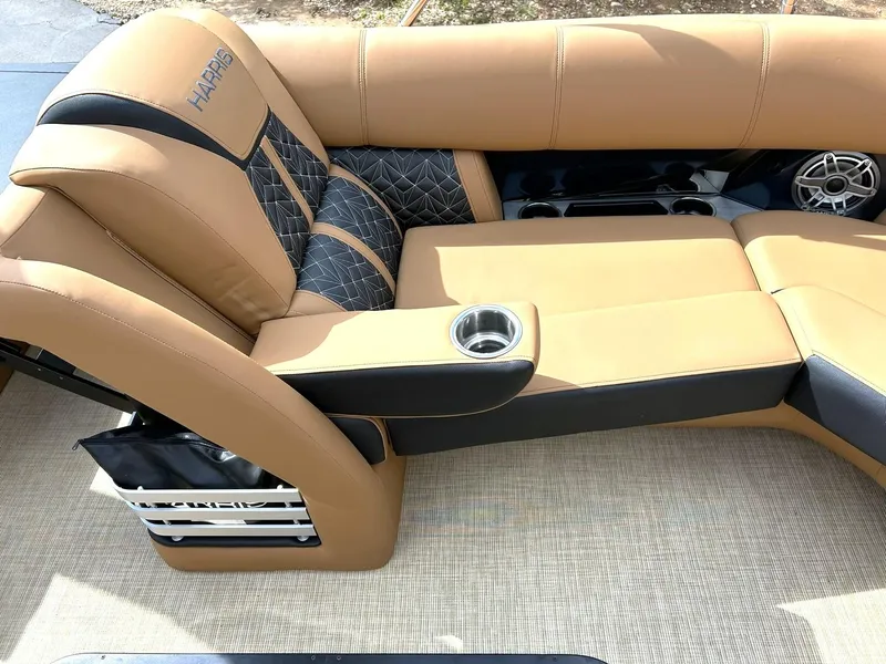 Slide: The Image of Luxurious seating on 2023 Harris Grand Mariner 230 boat, featuring tan upholstery and cup holders. - 49