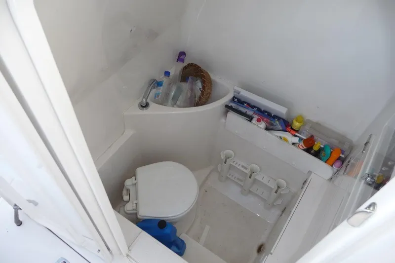 Slide: The Image of Compact boat bathroom with toilet and storage, 2004 Jupiter Open Center Console. - 7