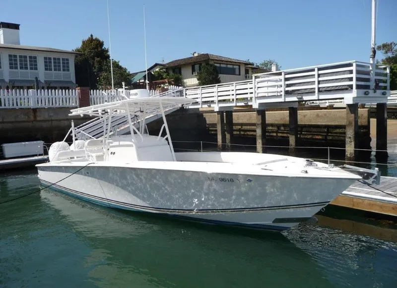 Slide: The Image of 2004 Jupiter Open Center Console boat docked near waterfront homes. - 9