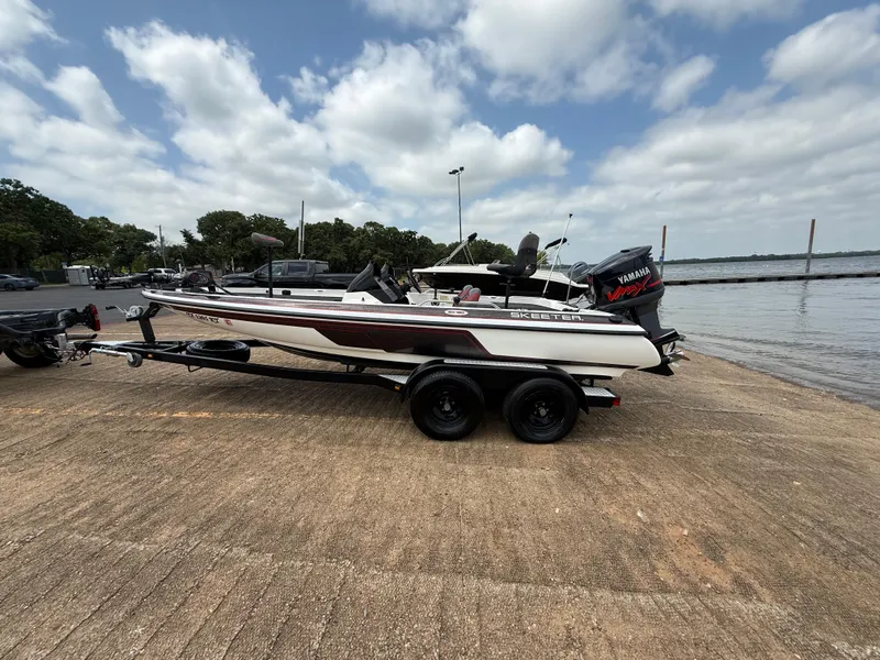 Slide: The Image of 2003 Skeeter SX190 boat on trailer by lakeside under cloudy sky. - 5