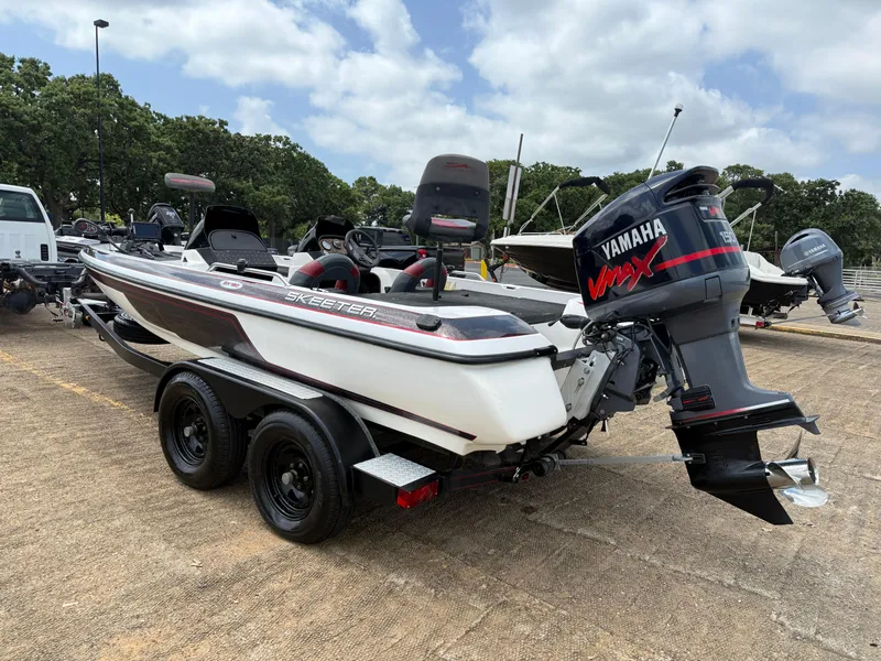 Slide: The Image of 2003 Skeeter SX190 boat with Yamaha VMAX engine on trailer in parking lot. - 8