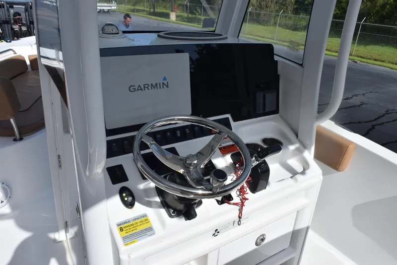 Slide: The Image of 2019 Sea Hunt Ultra 235 SE boat dashboard with Garmin navigation system and steering wheel. - 10