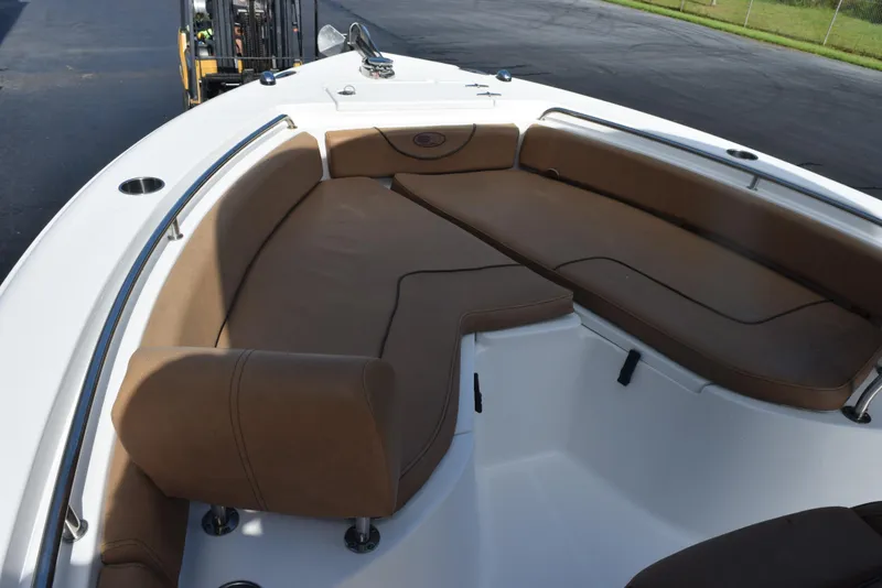 Slide: The Image of 2019 Sea Hunt Ultra 235 SE boat with brown cushioned seating area. - 12