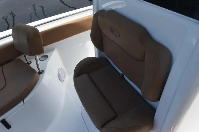 Slide: The Image of 2019 Sea Hunt Ultra 235 SE boat interior with brown cushioned seating. - 13