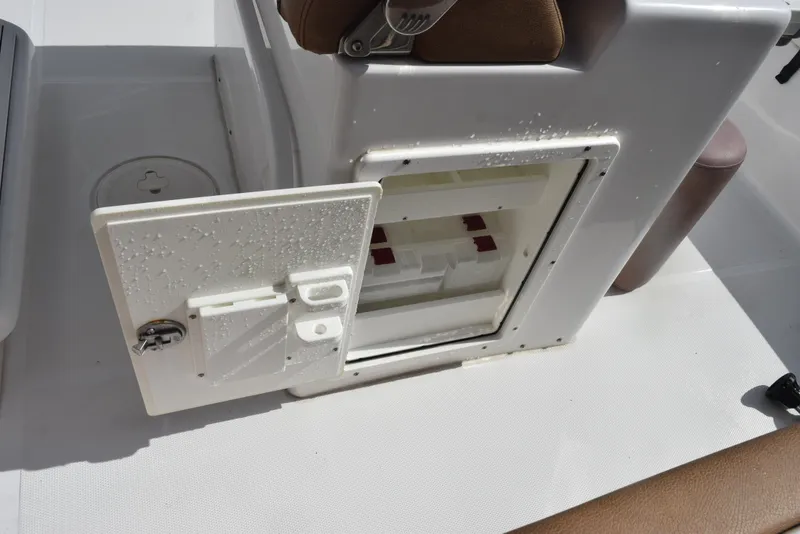 Slide: The Image of Open storage compartment on 2019 Sea Hunt Ultra 235 SE boat. - 17