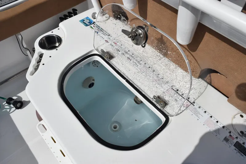 Slide: The Image of Livewell on 2019 Sea Hunt Ultra 235 SE boat with transparent lid and measuring ruler. - 19
