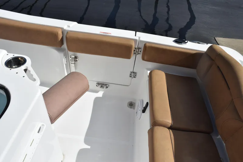 Slide: The Image of 2019 Sea Hunt Ultra 235 SE boat interior with tan seating and cup holder. - 20